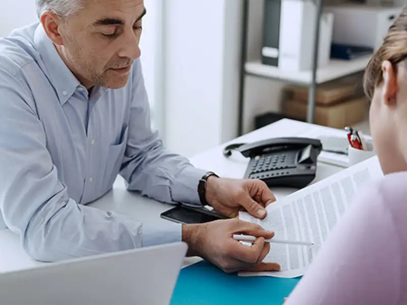 Man going over documents with a client.